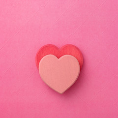 Fototapeta premium couple of wooden heart in love on red background. Hearts concept. Copy space.