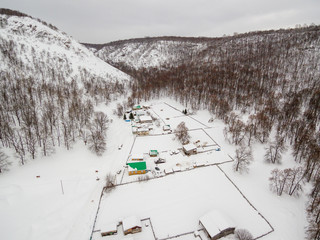 Southern Urals. Bashkir village of Makarovo in the mountains in winter. Aerial view.
