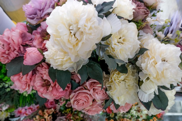 Artificial flower composition in floral shop. Floral theme, making bouquets.