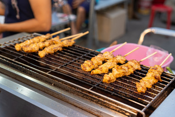 Crocodile meat grilled on a gas stove Sold at Amphawa floating market. Samut Songkhram Province, Thailand