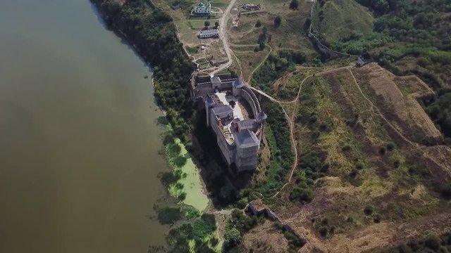 Aerial view of medieval castle near the river. Hotyn Castle in Ukraine