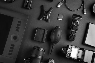 Flat lay composition with video production equipment for camera on black background