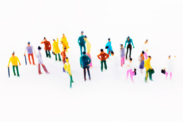Many business people plastic toy on top of a white background, isolated, with out of focus figurines standing - Horizontal banner