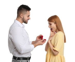 Man with engagement ring making marriage proposal to girlfriend on white background