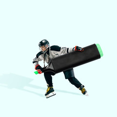 Hockey player using huge marker like stick on blue background. Copyspace for your proposal. Modern design. Contemporary artwork, collage. Concept of sport, office, work, dreams, business, action.