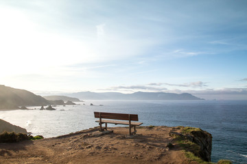 Fototapeta na wymiar Inviting bench on a cliff