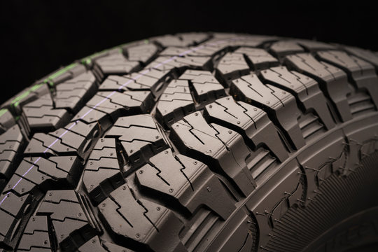 mud all terrain tires for SUVs on a black background close-up, emphasis on the wheel tread. a true conqueror of off-road terrain