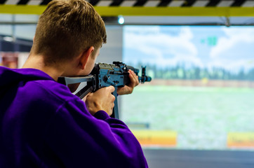 Guy shooting in virtual shooting gallery