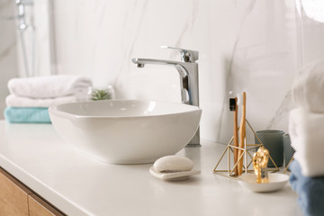 Stylish vessel sink on light countertop in modern bathroom