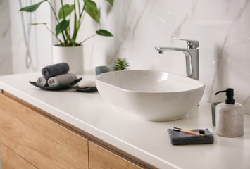 Obraz na płótnie Canvas Stylish vessel sink on light countertop in modern bathroom