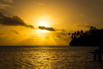 Fototapeta na wymiar Orange cloudy sky on the tropical beach