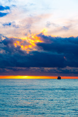 Sea sunset landscape with ship on the horizon