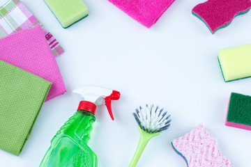 brush, towels, glass cleaner, rag and sponges on a white background