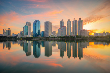 Fototapeta premium cityscape building skyline of skyscraper in modern city downtown on morning the landmark in Bangkok Thailand for business and travel center. golden hour sky and cloud landscape.