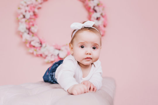 Image of sweet adorable baby girl with pink flowers