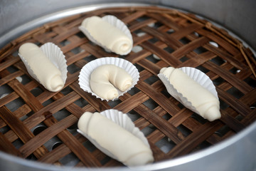 Hot steamed buns and mantou on bamboo steamer.