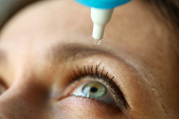 Woman drops eye drops to check vision, prevention
