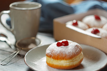 Freshly donuts with jam with powdered sugar