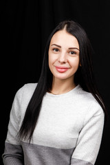 Portrait of serious beautiful female with black hair, has minimal makeup, looks calmly at camera,...