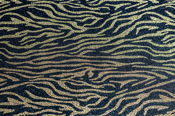 Abstract gold sparkles on a black background. For backgrounds, cards, banners.