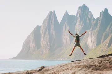 Schilderijen op glas Man jumping enjoying landscape travel active healthy lifestyle outdoor  adventure vacations in Norway success  happy emotions Okshornan peaks view © EVERST