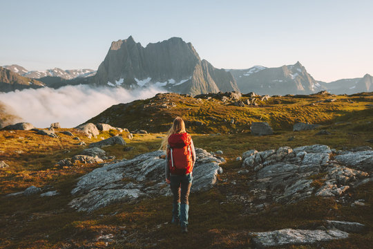 Woman traveler hiking in mountains with backpack adventure travel healthy lifestyle active summer vacations explore Norway
