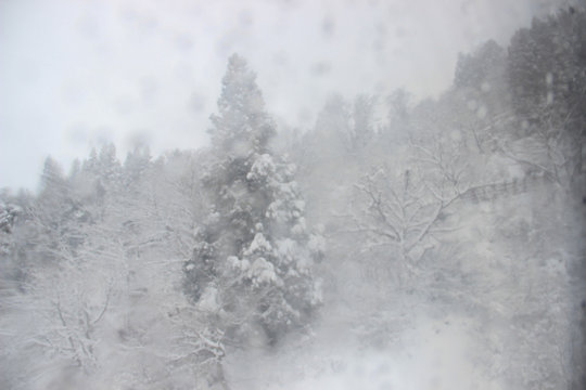 A heavy snowstorm while on a moving cable car looking at the window © Komkrich