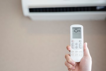 Air conditioner inside the room with  operating remote controller.save world save life.