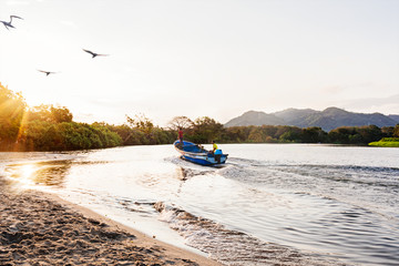 the fisherman is fishing on a river in the early morning