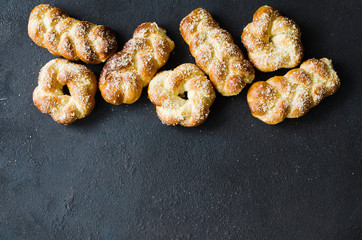 Baked fresh fragrant buns. Traditional homemade pastries. Pigtail buns top view.