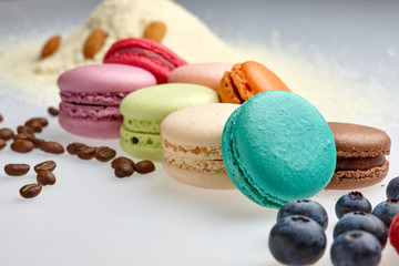 round baked almond flour macaron isolated on a white background, delicious popular french dessert coffee beans almond Strawberry malina raspberries blueberries flour