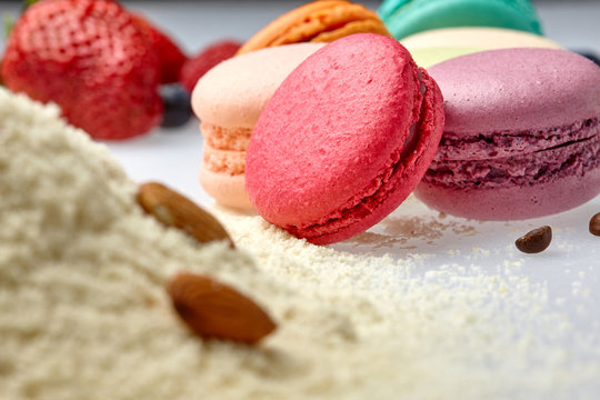 round baked almond flour macaron isolated on a white background, delicious popular french dessert coffee beans almond Strawberry malina raspberries blueberries flour