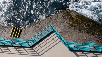 Blue railings, shadows and terraces at the seaside