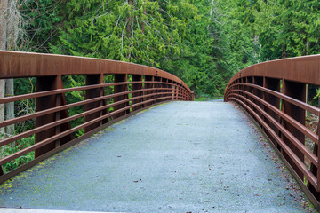 Landscape of a wooden bridge in the forest at Sequim Bay State Park in Washington