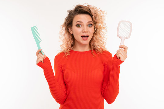 Beautiful Woman Holds Two Hairbrushes And Smiles