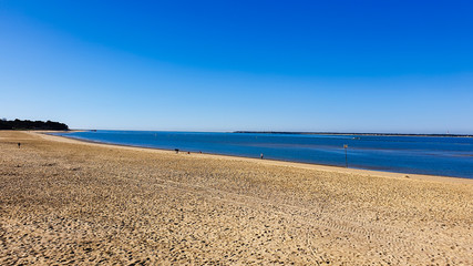 almost deserted beach and calm sea under azure sky