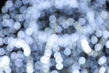Diffused silver and white bokeh Black background at night