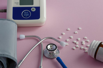 Medical tonometer, stethoscope and white tablets.   Medical concept. Selective focus. Space for text.