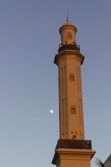 Minaret tower of Dubai Creek with the moon