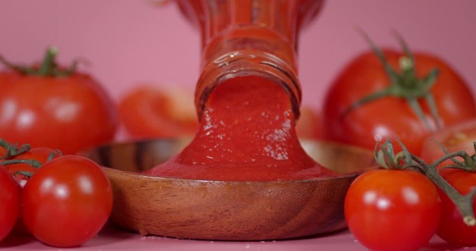 Pour tomato ketchup from a glass bottle.