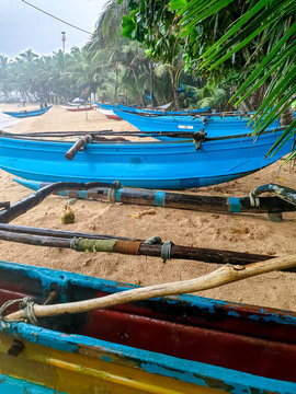 Beautiful image of traditional old wooden fishing boats of Sri Lanka or India got wet after heavy tropical rain