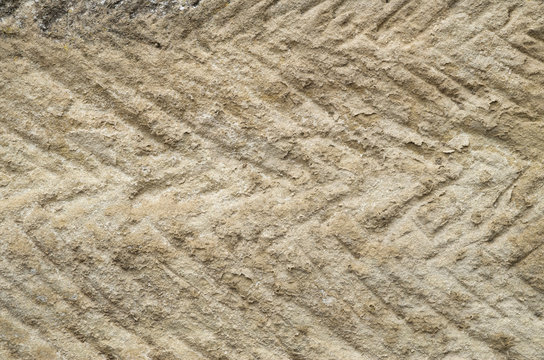 Processed sandstone with oblique parallel lines
