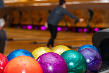Fototapeta na wymiar Colorful and vibrant bowling balls, with lanes in the background, with copy space