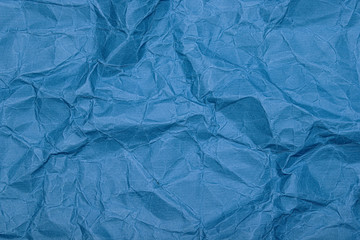 Crumpled paper (cardboard) background. Crumpled old vintage blue wrapping paper with texture