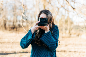 Teen girl with instant camera