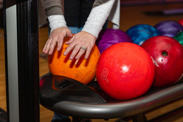 Fototapeta na wymiar Bowler drying hands in front of bowling balls