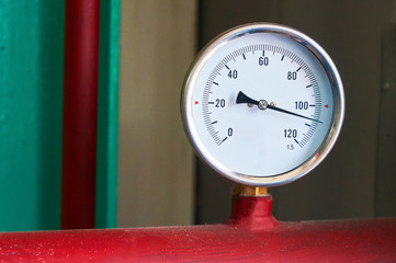 Round temperature sensor on the hot water pipe.