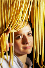 Portrait of italian woman, as  chef, with noodles