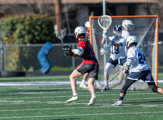 Young athletes making amazing plays while playing in a Lacrosse game - Powered by Adobe