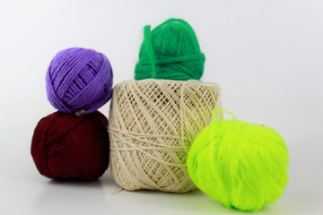 Multicolor yarn around a cream yarn isolated on white background
